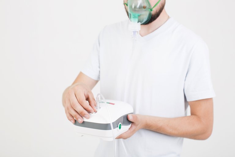 Person using a nebulizer for respiratory support