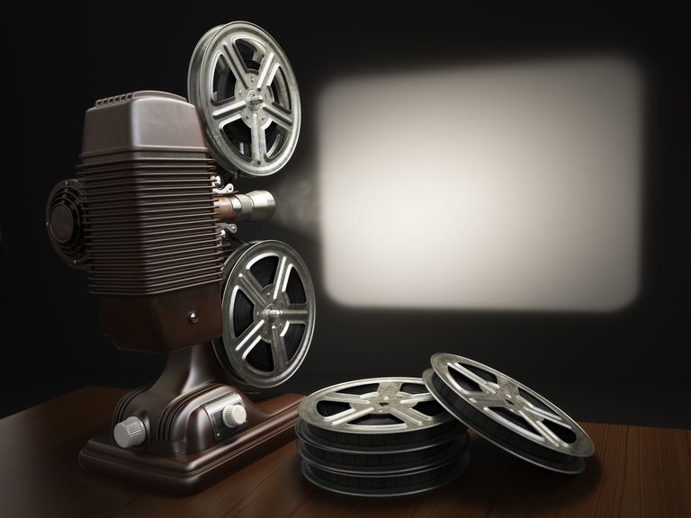 A vintage film projector casting light onto a blank screen, the memory projector at the center of this exercise